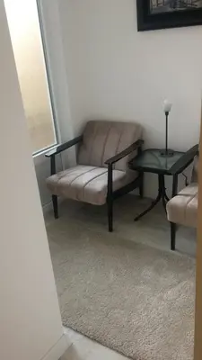 a living room with a chair and a table at Cricket Park Hostel in Belgrade