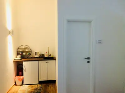a white door in a kitchen with a counter at Cricket Park Hostel in Belgrade