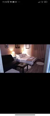 a room with two beds and a table in it at Apartments Forest in Belgrade