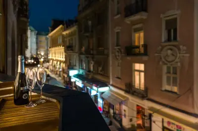 a bottle of wine and glasses sitting on a table at Delights Apartment Belgrade in Belgrade