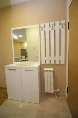 a bathroom with a white vanity and a mirror at Luna Lux Apartman in Belgrade