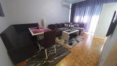 a living room with a couch and a table at Cezar Apartment in Belgrade