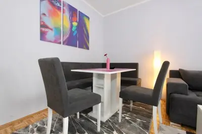 a waiting room with a table and two chairs at Cezar Apartment in Belgrade