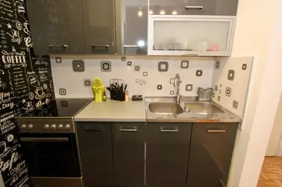 a small kitchen with a sink and a stove at Cezar Apartment in Belgrade