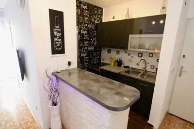 a kitchen with a counter top and a sink at Cezar Apartment in Belgrade