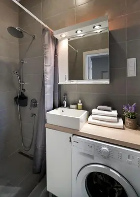 a bathroom with a washing machine and a sink at Brigitte's Central in Belgrade