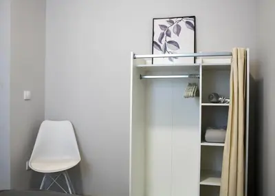 a closet with a white door and a chair at Brigitte's Central in Belgrade
