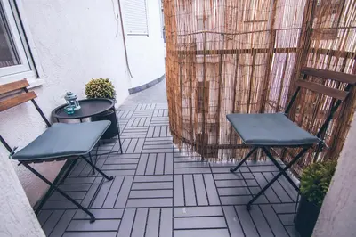 a pair of chairs and a table on a balcony at Brigitte's Central in Belgrade