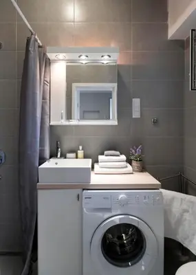 a bathroom with a washing machine and a sink at Brigitte's Central in Belgrade