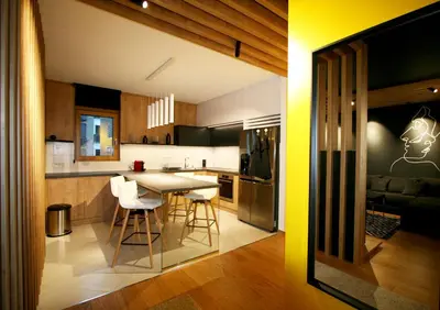 a kitchen and living room with a table and chairs at Apartment Gotham in Belgrade