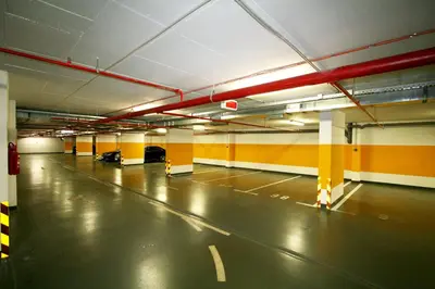 an empty parking garage with yellow and orange walls at Apartment Gotham in Belgrade
