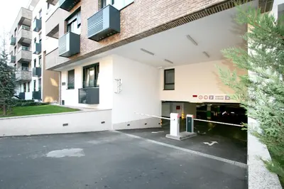 a parking lot in front of a building at Apartment Gotham in Belgrade