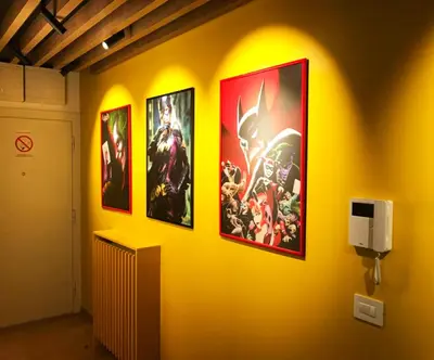 a yellow wall with four pictures on it at Apartment Gotham in Belgrade