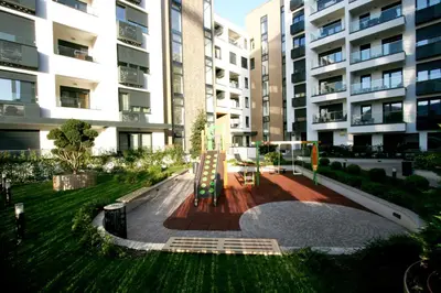 a park in front of a large apartment building at Apartment Gotham in Belgrade