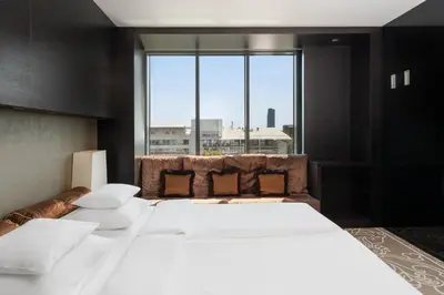 a large bed in a room with a large window at Zijin Hotel Belgrade in Belgrade
