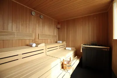 a sauna with wooden paneled walls and wooden benches at Zijin Hotel Belgrade in Belgrade