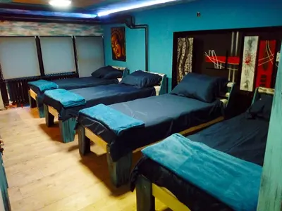 a room with four beds with blue sheets at NapPARK Hostel in Belgrade