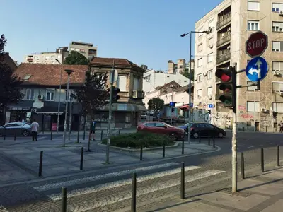 a street with a stop sign and cars on the road at DOWNTOWN STUDIO AP in Belgrade