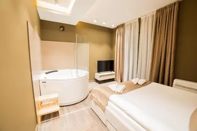 a bedroom with a bed and a bath tub at Belgrade Center Luxury Apartments in Belgrade