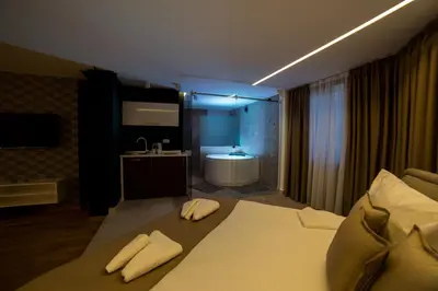 a bedroom with a bed and a bathroom with a tub at Belgrade Center Luxury Apartments in Belgrade