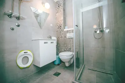 a bathroom with a toilet and a glass shower at Lola Almost Home in Belgrade