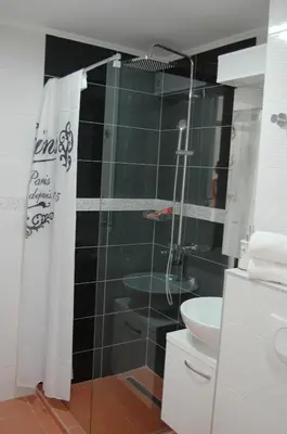 a bathroom with a shower and a toilet and a sink at FIVE in Belgrade
