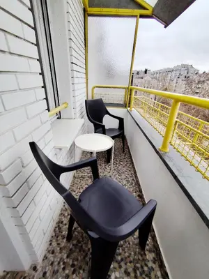 a room with two chairs and a table on a balcony at FIVE in Belgrade