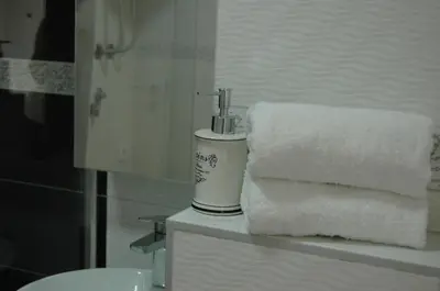 a pile of towels sitting on a counter in a bathroom at FIVE in Belgrade