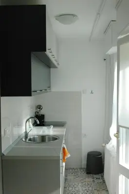 a kitchen with a sink and a black and white at FIVE in Belgrade