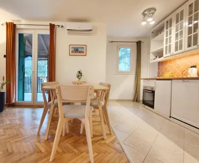 a kitchen and dining room with a table and chairs at Dunavski konaci in Brestovik
