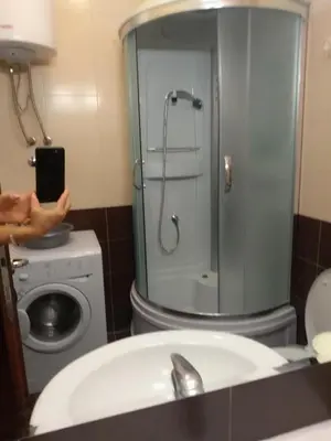 a person taking a picture of a shower in a bathroom at Apartman Nina Vojvode Stepe Vozdovac in Voždovac