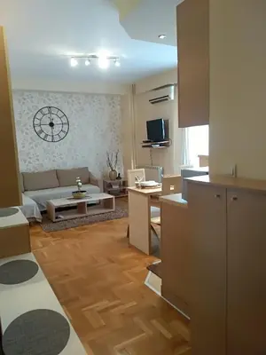 a living room with a couch and a table at Apartman Nina Vojvode Stepe Vozdovac in Voždovac