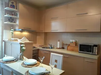 a kitchen with a table with plates on it at Apartman Nina Vojvode Stepe Vozdovac in Voždovac