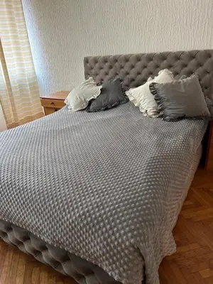 a bed with three pillows on top of it at Beo shooping centar in Belgrade