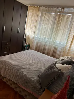 a bedroom with a bed and a window with curtains at Beo shooping centar in Belgrade