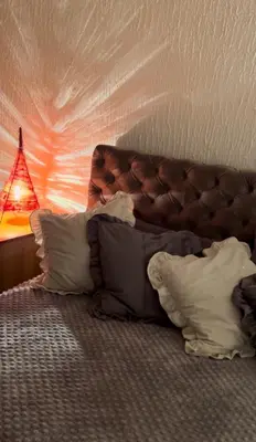 a bedroom with a bed with pillows and a lamp at Beo shooping centar in Belgrade