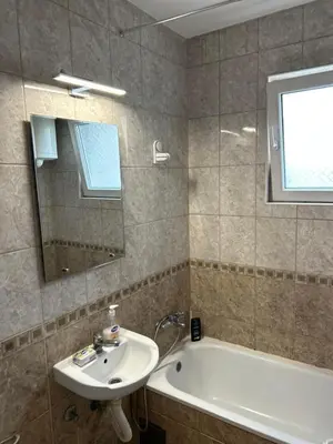 a bathroom with a sink and a tub and a mirror at Beo shooping centar in Belgrade