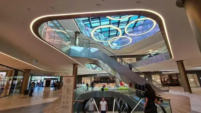 a large shopping mall with a escalator in the ceiling at Beo shooping centar in Belgrade