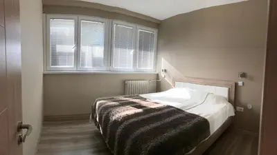 a bedroom with a bed with a blanket on it at Lovely Apartment 2 in Belgrade
