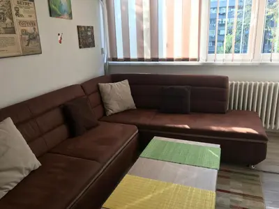 a brown leather couch in a living room at Lovely Apartment 2 in Belgrade