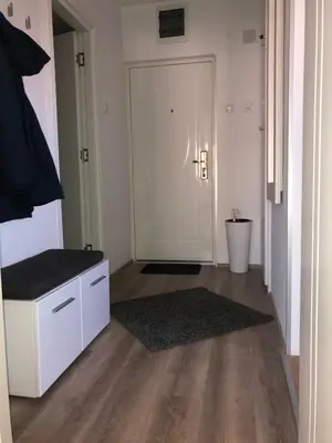 a room with a hallway with a door and a rug at La Fontana in Belgrade