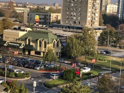 a church with a parking lot in a city at La Fontana in Belgrade