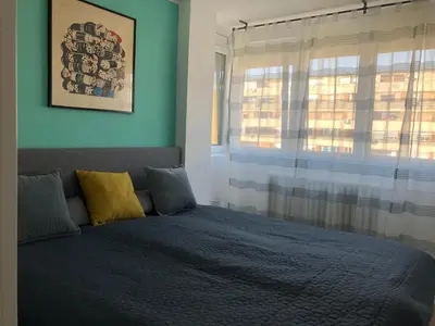 a bedroom with a bed in front of a window at La Fontana in Belgrade