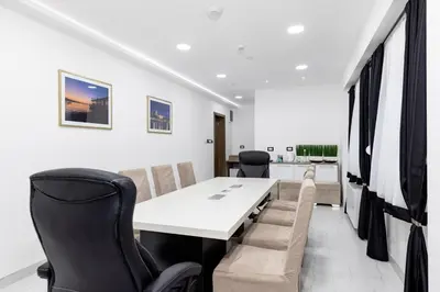 a meeting room with a white table and chairs at ForS Resort & Spa in Belgrade