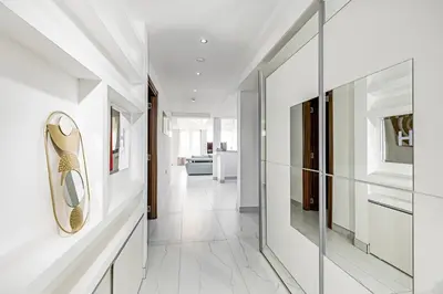 a hallway with white walls and a glass wall at ForS Resort & Spa in Belgrade