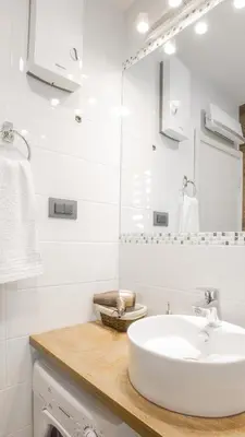 a white bathroom with a sink and a mirror at Casablanca apartment in Belgrade