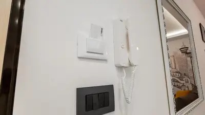 a mirror and a phone hanging on a wall at Casablanca apartment in Belgrade