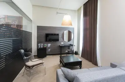 a living room with a couch and a table at Hotel Grand Hedonist in Pančevo