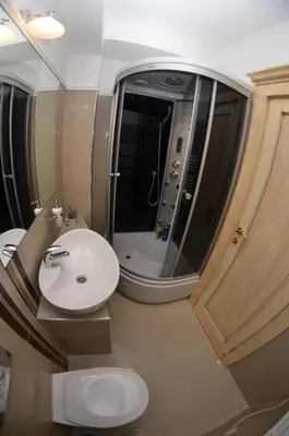 a bathroom with a sink and a toilet and a mirror at Villa Skadarlija in Belgrade