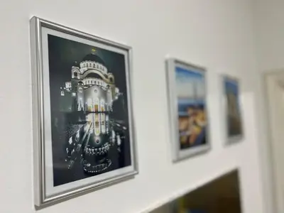 a framed picture of a building on a wall at Hardy's Apartment in Belgrade
